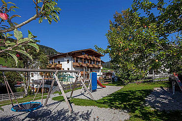 © Landhotel Tirolerhof/ Thomas Trinkl - Hotelansicht mit eigenem Kinderspielplatz